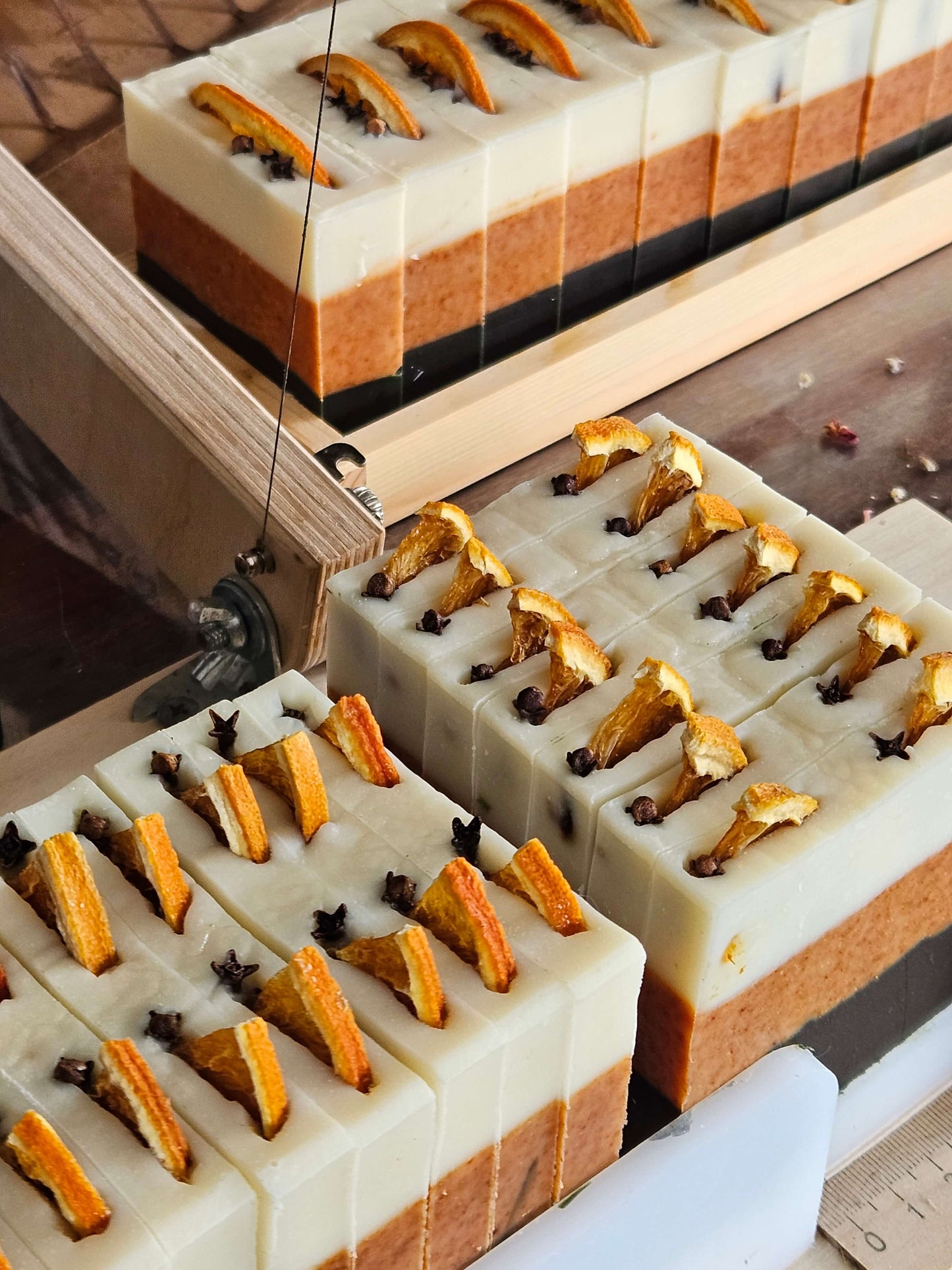 thin spice soap bars on the soap cutter ready to be cut into thin slices
